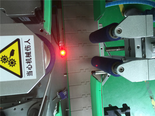 Ardo gorri bertikalak etiketatzeko makina automatikoak txandakako botila biribilgarriak dituzten elikagaien sistema etiketa gardenak etiketa makineria automatikoa